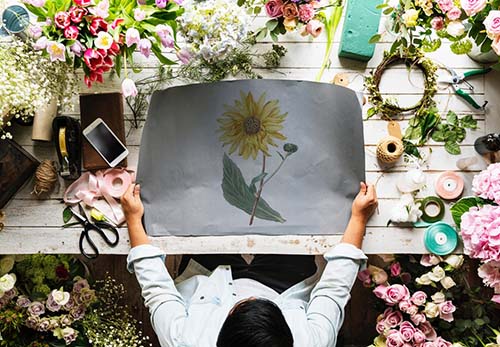 man holding a picture of flower