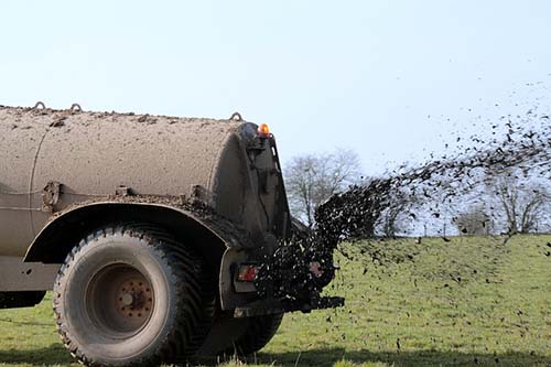 truck spraying fertilizer in the field